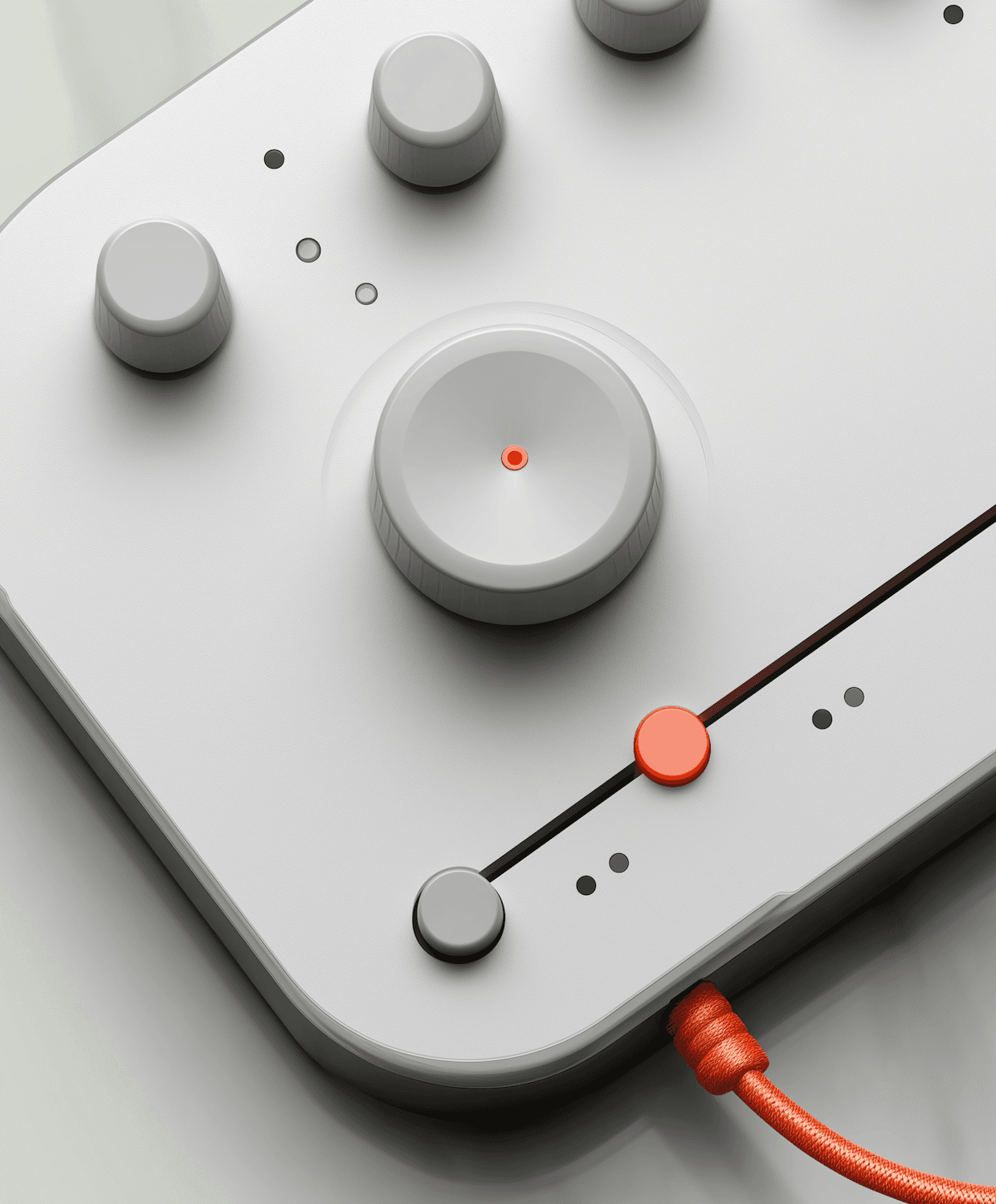 A control panel with rotary knobs, a slider and an orange braided cable